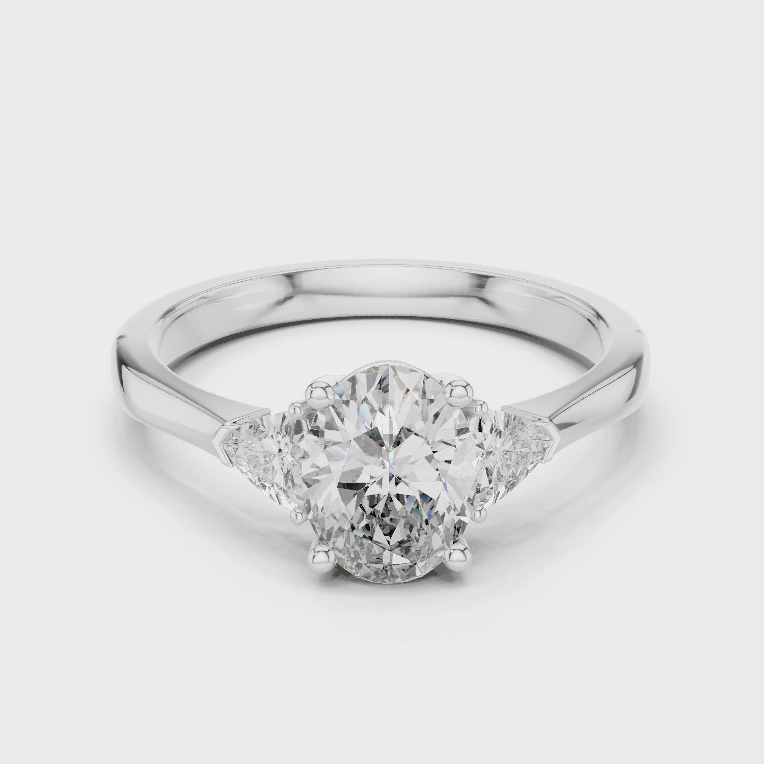 White Gold Oval Cut Diamond Engagement Ring with Tapered Trilliant Stones